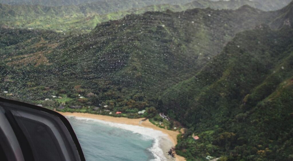 Private helicopter transfer over tropical coastline near Shaka Caye island resort, Belize